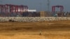 FILE - An engineer walks through a part of a construction site of Chinese investment "Colombo Port City" in Colombo, February 20, 2015.