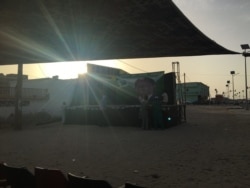 As the sun sets, campaign volunteers prepare to engage visitors about opposition candidate Kane Hamidou Baba (Photo: E. Sarai)