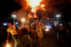 Supporters of Syria's President Bashar al-Assad celebrate after the results of the presidential election announced that he won a fourth term in office, in Damascus, Syria, May 27, 2021.