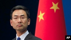 Chinese Foreign Ministry spokesman Geng Shuang listens to a question from a reporter during a daily briefing at the Ministry of Foreign Affairs office in Beijing, March 18, 2020.