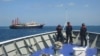 Philippines sends ships to disputed atoll, says China building 'artificial island'