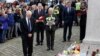 Britain's Prime Minister David Cameron, second from right, stands with Labour Party leader Jeremy Corbyn, left, John Bercow, Speaker of the House of Commons, center, and Labour MP Hilary Benn, second left, as they pay tribute near the scene where Labour Member of Parliament Jo Cox was killed in Birstall, near Leeds, June 17, 2016.