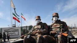 Tentara Pakistan yang mengenakan masker berpatroli di dekat perbatasan Pakistan-Iran yang tertutup di Taftan pada 25 Februari 2020. (Foto: AFP)