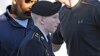 Army Pfc. Bradley Manning is escorted into a courthouse at Fort Meade, Md., June 4, 2013.