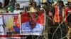 Sudanese protesters rally in front of a court in Omdurman near the capital Khartoum, Dec. 30, 2019, during the trial of intelligence agents for the death of teacher Ahmed Al-Khair, portrait at right, while in custody of intelligence services. 