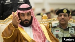 Saudi Crown Prince Mohammed bin Salman gestures during a military parade by Saudi security forces in preparation for the annual Haj pilgrimage in the holy city of Mecca, Saudi Arabia, Aug. 23, 2017.