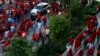 Members of the Economic Freedom Fighters party holds placards during their march for economic transformation outside the Johannesburg Stock Exchange in Johannesburg, Oct. 27, 2015.