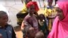 Abdiya Golicha, wearing pink, lives in northern Kenya's Marsabit County and volunteers to help Ethiopian refugees at the Dambala Fachana camp. (D. Gelmo/VOA)
