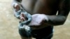 A member of the Amazonian Tatuyo tribe holds a snake while waiting for tourists in his village in the Rio Negro (Black River) near Manaus city, Brazil, June 23, 2014.