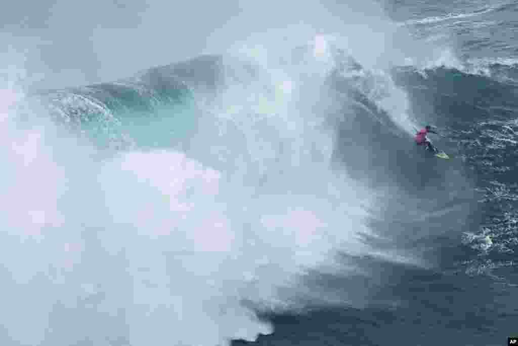 Lucas "Chumbo" Chianca from Brazil rides a wave during the Nazare Big Wave Challenge surfing tournament at Praia do Norte, or North Beach, in Nazare, Portugal.