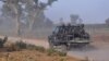 FILE - Members of the Cameroonian Rapid Intervention Battalion patrol on the outskirts of Mosogo in the far north region of the country, March 21, 2019.