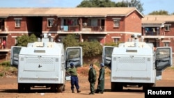 FILE - Police patrol during a 21-day nationwide lockdown called to help curb the spread of coronavirus disease, in Harare, Zimbabwe, April 3, 2020. 