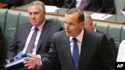 Australia's Prime Minister Tony Abbott speaks about the nation's new anti-extremism strategy during a question time at Parliament House in Canberra, Australia, Feb. 23, 2015.