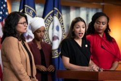 FILE - U.S. Rep. Alexandria Ocasio-Cortez, D-N.Y., speaks as, from left, Rep. Rashida Tlaib, D-Mich., Rep. Ilhan Omar, D-Minn., and Rep. Ayanna Pressley, D-Mass., listen during a news conference at the Capitol in Washington, July 15, 2019.