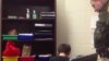 A screengrab from the video showing officer Kevin Sumner handcuffing one of the students.