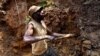 One of few remaining miners digs out soil which will later be filtered for traces of cassiterite, the major ore of tin, at Nyabibwe mine, in eastern Congo, Aug. 7, 2012.