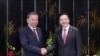 Vietnamese Party General Secretary To Lam (L) and Singaporean Prime Minister Lawrence Wong shake hands at their meeting in Singapore, March 12, 2025.