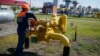 FILE - A worker turns a valve at an underground gas storage facility near Striy, Ukraine, May 21, 2014.
