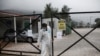 A man wearing a protective suit to protect against coronavirus leaves a migrant facility at Malakasa village, north of Athens, April 5, 2020.