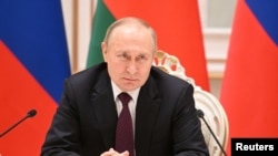 Russian President Vladimir Putin attends a news conference with Belarusian President Alexander Lukashenko following their meeting in Minsk, Belarus Dec. 19, 2022. 