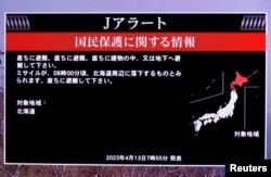 A TV screen displays a warning message called "J-alert" after the Japanese government issued an alert, following a ballistic missile launch by North Korea