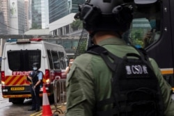 Police officers stand outside a court in Hong Kong Aug. 19, 2021. Two Hong Kongers on Thursday pleaded guilty to conspiring to collude with foreign forces as well as Next Digital founder Jimmy Lai to endanger national security according to reports.