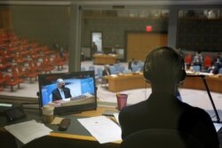 Afghanistan's U.N. ambassador Ghulam Isaczai is seen on a monitor in a translators booth as the United Nations Security Council meets regarding the situation in Afghanistan at the United Nations in New York City, New York, Aug. 16, 2021.