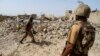 FILE - Pakistani soldiers stand near debris of a house which was destroyed during a military operation against Islamist militants in the town of Miranshah, North Waziristan, Pakistan, July 9, 2014. 
