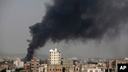 FILE - Smoke rises after Saudi-led airstrikes hit a food factory in Sanaa, Yemen, Aug. 9, 2016. 