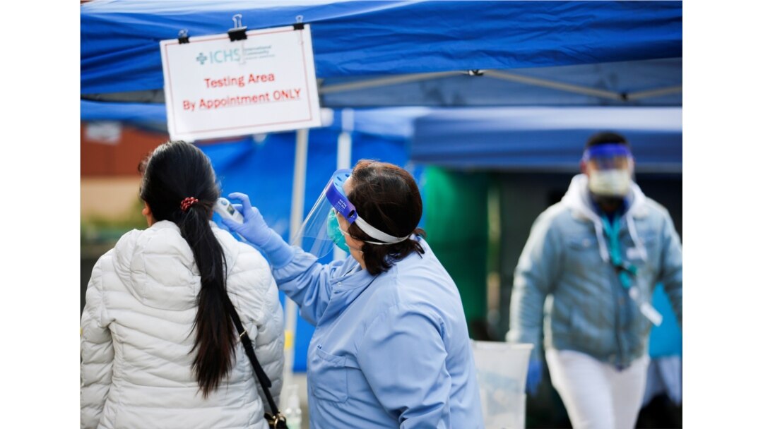 A person gets their temperature checked before entering International Community Health Services in the Chinatown-International District during the coronavirus disease (COVID-19) outbreak in Seattle, Washington, March 26, 2020.