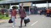 FILE - Students leave the campus at the North-West University in Mahikeng, South Africa, (also known as Mafikeng) Feb. 25, 2016. 