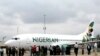 FILE - Journalists gather next to a Nigerian Eagle Airlines plane during its launch in Nigeria's commercial capital of Lagos, Sept. 18, 2009.