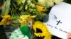 A "Pray for Orlando" card sits with part of a makeshift memorial outside the Dr. Phillips Center for the Performing Arts for victims of the fatal shootings at the Pulse Orlando nightclub in Orlando, Florida, June 13, 2016.