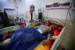 A man is treated at a hospital after he was injured during last night's rocket attack on U.S.-led forces in and near Irbil International Airport, in Irbil, Iraq, Feb. 16, 2021.