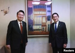 South Korea's President Yoon poses for a photograph with Japan's PM Kishida in Tokyo
