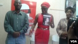 Jestina Mukoko (center) with Concelia Chinanzvavana and her husband, Emmanuel. 