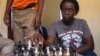 18-year-old Phiona Mutesi plays a game of chess with her colleagues at the chess academy in Kibuye, Kampala, Jan. 26, 2015. 