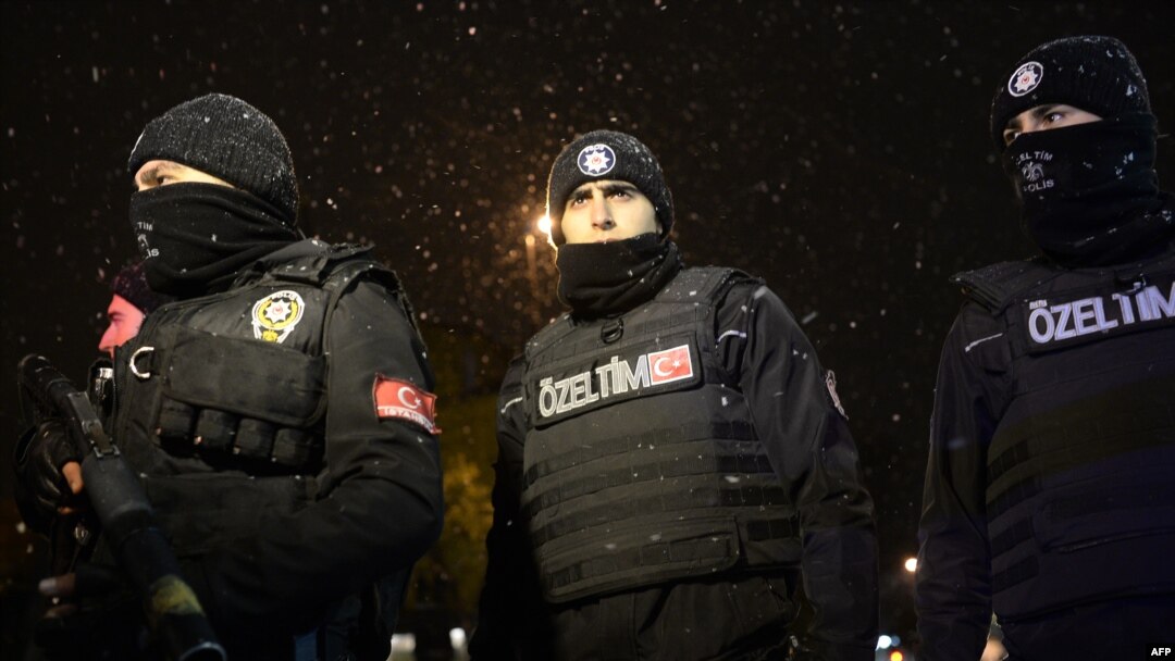 Police officers look on after a female suicide bomber died when she blew herself up in an attack on a police station in central Istanbul, the city governor said, Jan. 6, 2015.