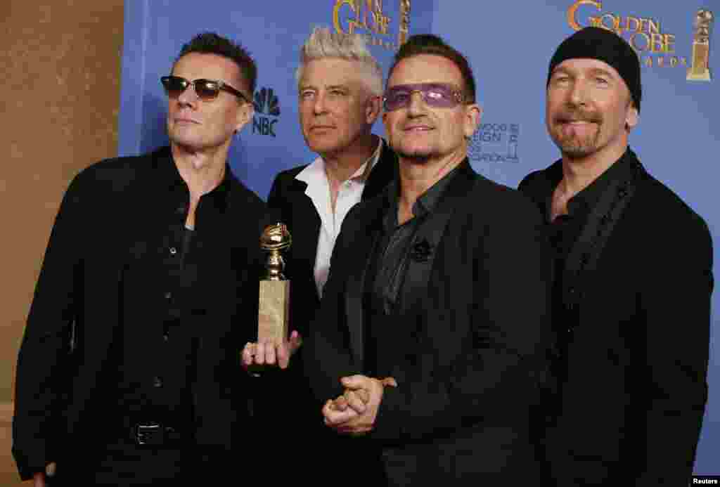 Adam Clayton, Bono, Larry Mullen, Jr. and The Edge from the band U2 pose backstage with their award for Best Original Song for" Ordinary Love" from the film "Mandela: Long Walk to Freedom" Jan. 12, 2014.