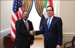 U.S. Treasury Secretary Steven Mnuchin, right,meets with Sudan's Prime Minister Abdalla Hamdok in Washington, Dec. 3, 2019.