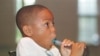 FILE - Alexander McBride, 8, who has asthma, exhales into a peak flow meter in Severna Park, Maryland, Aug. 13, 1998.