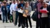 FILE - People wait in line to enter the Nassau County Mega Job Fair at Nassau Veterans Memorial Coliseum in Uniondale, N.Y., Oct. 7, 2014. 