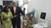 FILE - U.S. Secretary of State John Kerry and entrepreneur Patricia Nzolantima point at an ultrasound machine during a tour of a Sustainable Investment in Sub-Saharan Africa medical supply store in Kinshasa, DRC, May 3, 2014.