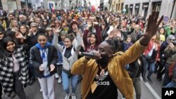 DJ Simon Samaki Osagie, with throngs of protesters behind him, sings during an anti-racism rally, in Milan, Italy, March 2, 2019