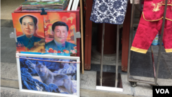 中國街頭出售的面孔可以變換的毛澤東和習近平像。