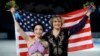 Meryl Davis and Charlie White of the U.S. pose for photographers after placing first in the Olympic ice dance free dance figure skating finals at the Iceberg Skating Palace in Sochi, Feb. 17, 2014.