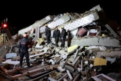 Rescue workers search on a collapsed building after an earthquake in Elazig, Turkey, January 25, 2020.