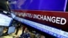A television screen on the floor of the New York Stock Exchange shows the rate decision by the Federal Reserve, Jan. 27, 2016. 