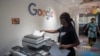 FILE - A woman makes copies at the Google Artificial Intelligence office in Accra, April 10, 2019 — the company's first AI center in Africa. The internet search giant announced in April 2022 that it is opening a product development center in Nairobi — its first in Africa. (AFP)