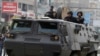 Riot police look from their armoured personnel vehicle during clashes with supporters of Muslim Brotherhood and ousted Egyptian President Mohamed Mursi at Nasr City district in Cairo, Jan. 3, 2014. (Reuters)